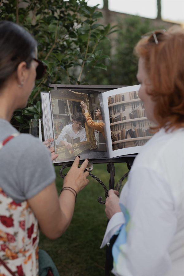 Due ospiti guardano le fotografie del libro